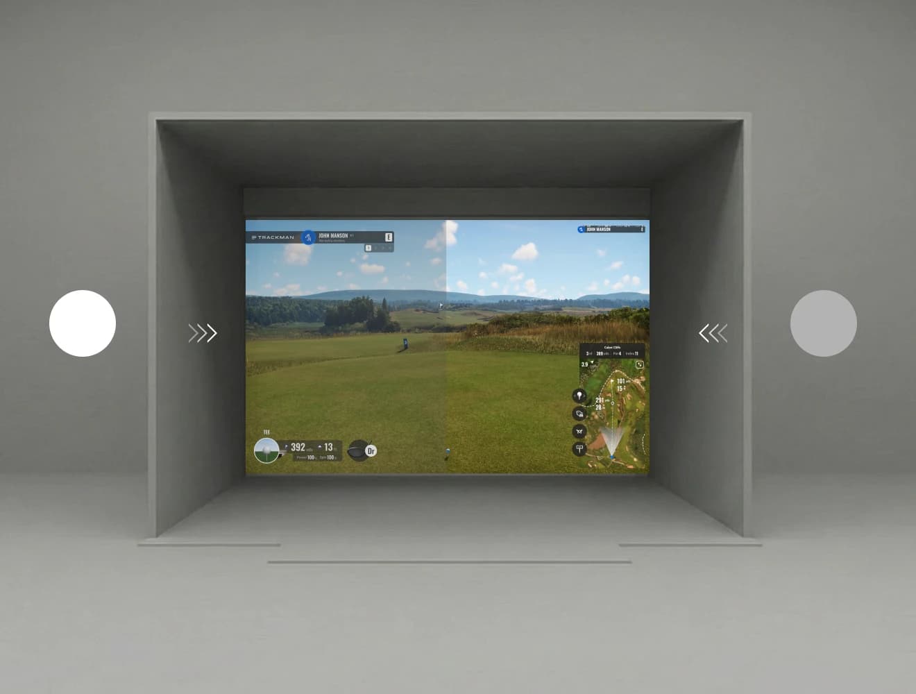 Golf simulator screen displaying a virtual landscape and course details, enclosed in a gray room with minimal design elements.