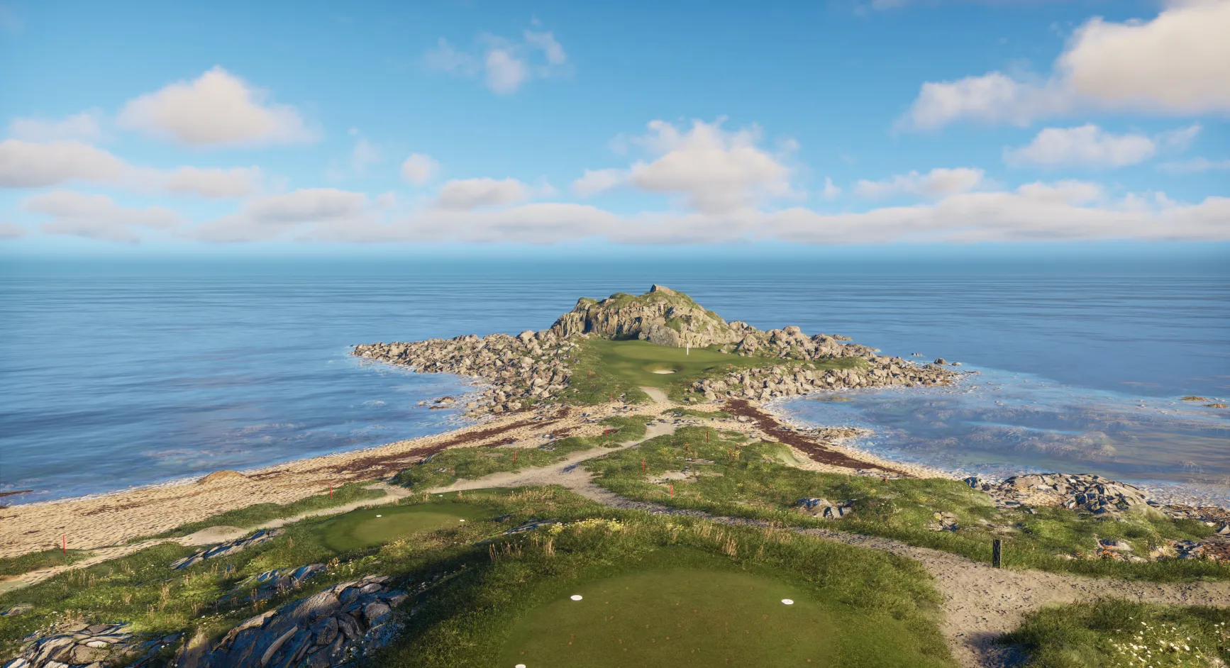 Coastal golf course with rocky terrain and ocean view under a blue sky with scattered clouds.